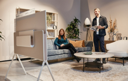 Photo of two people watching the LG Objet Collection Pose in a living room setting