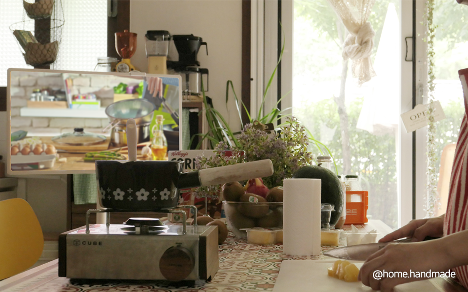 A photo of a person cooking with the LG StanbyME in front