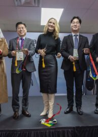 Participants smiling during a ribbon-cutting ceremony