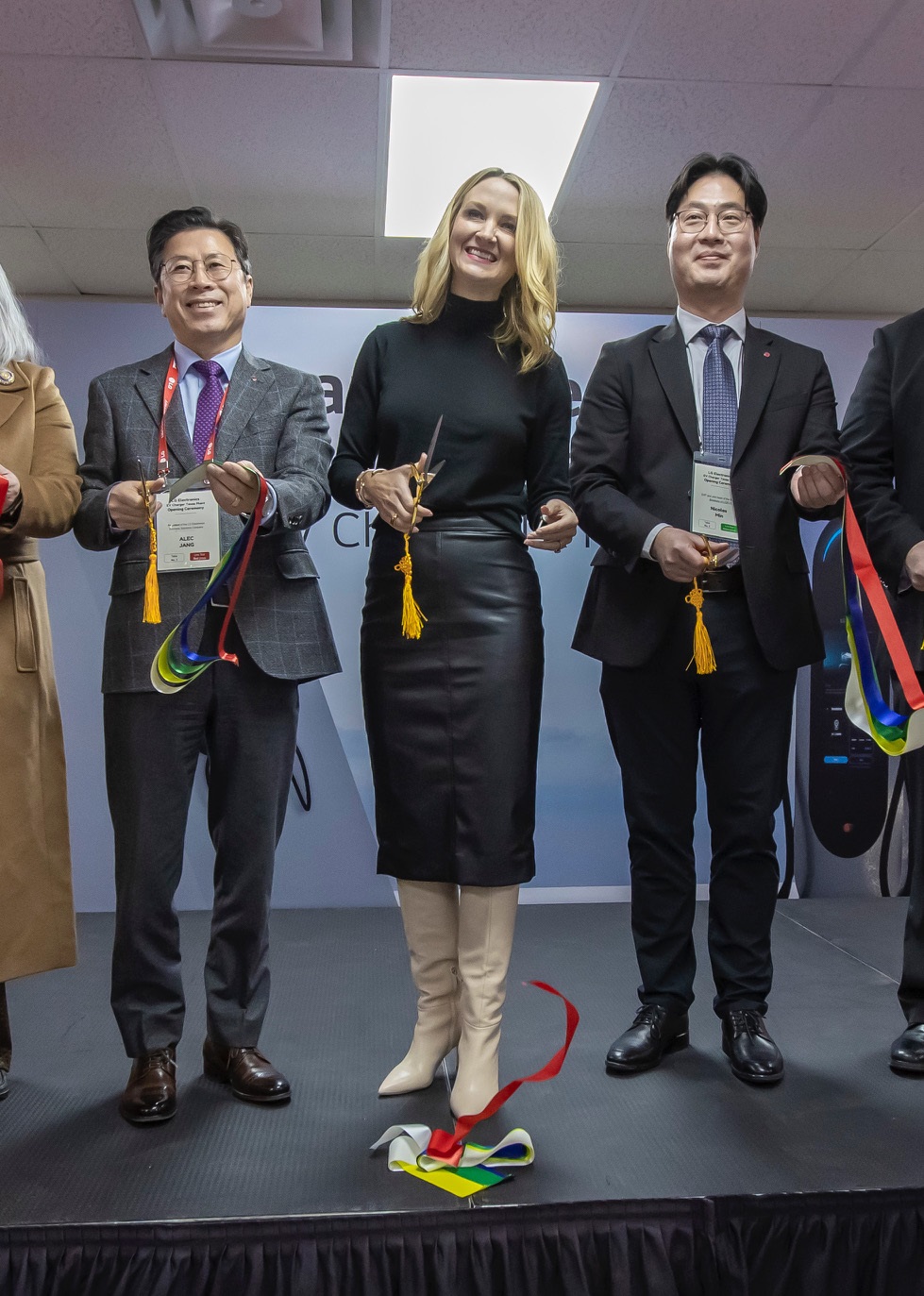 Participants smiling during a ribbon-cutting ceremony