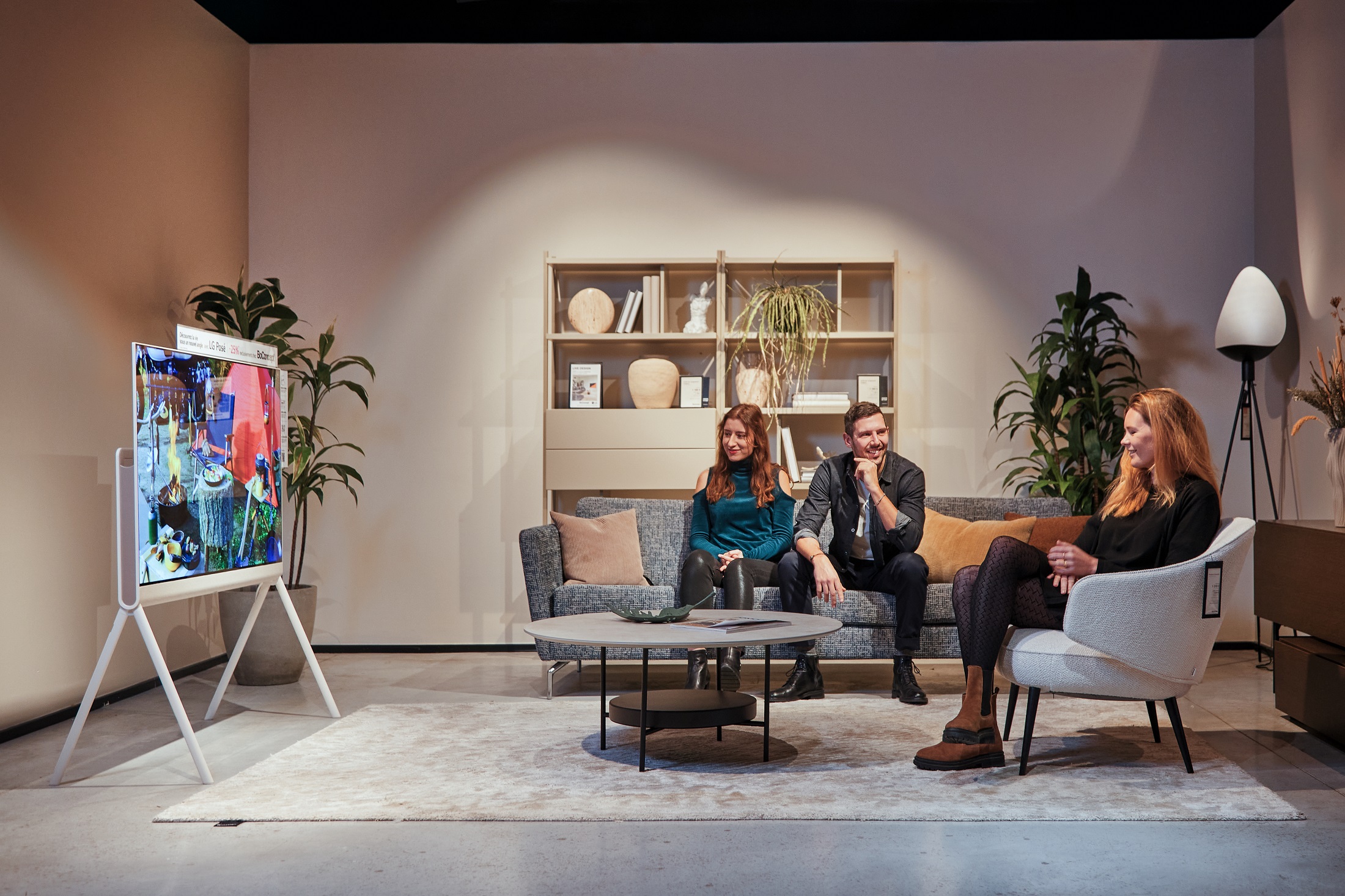 Three people sitting infront of the LG Objet Collection Pose