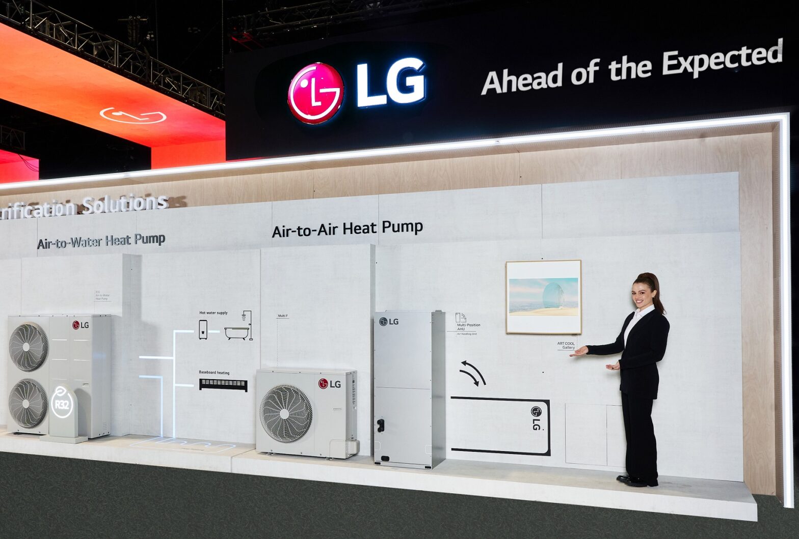 A photo of the LG Home Electrification Solutions Zone showcasing Energy Solutions, Air-to-Water Heat Pump, and Air-To-Air Heat Pump and a woman standing inside at AHR Expo 2024
