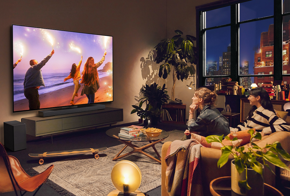 An image of two women watching television while sitting on a couch