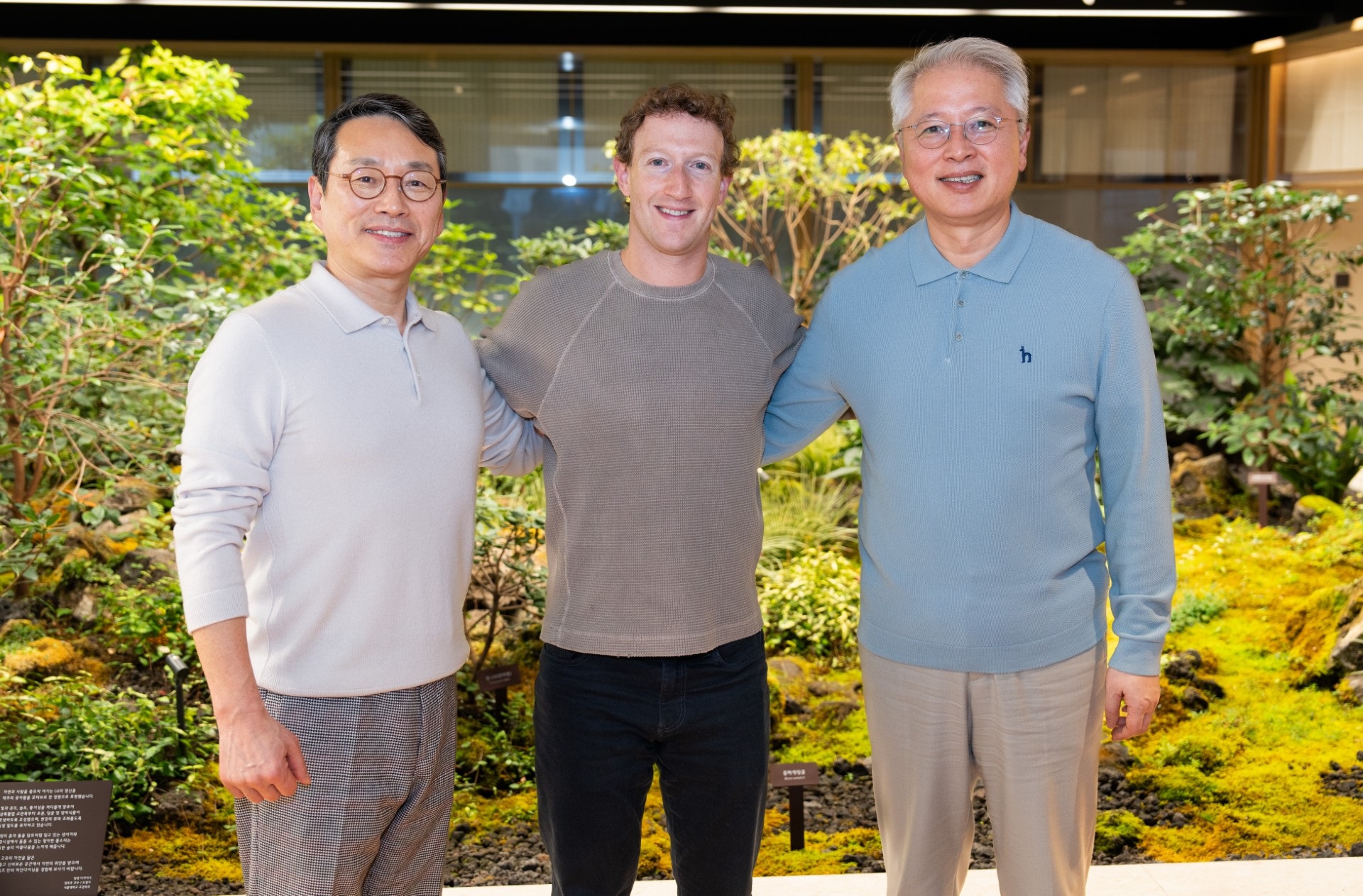 A photo of LG's CEO, Meta CEO and president of the Home Entertainment company standing next to each other