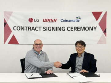 A photo of Jim Gimeson (CEO of WASH) and Sam Kim (Head of the Home Appliance Division at LG Electronics USA) shaking hands at the contract signing ceremony