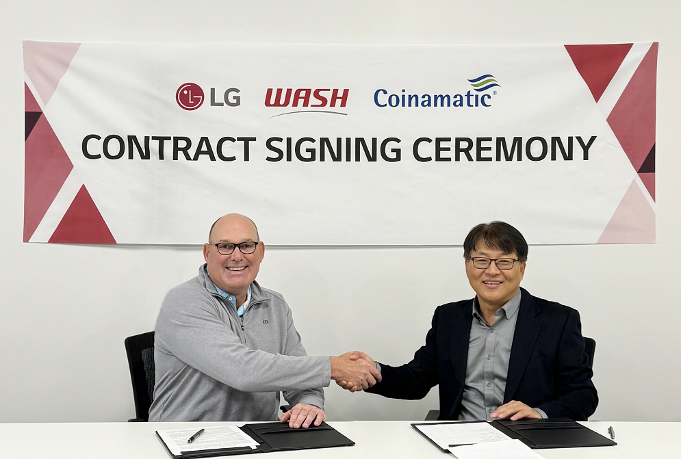 An image of Jim Gimeson (CEO of WASH) and Sam Kim (Head of the Home Appliance Division at LG Electronics USA) shaking hands at the contract signing ceremony