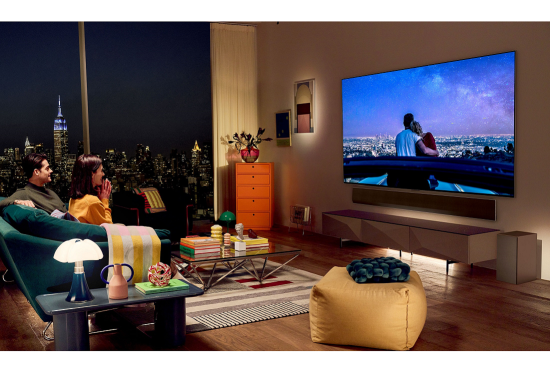 An image of a couple in their living room watching television