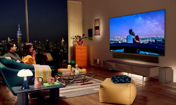 A photo of a couple in their living room watching television