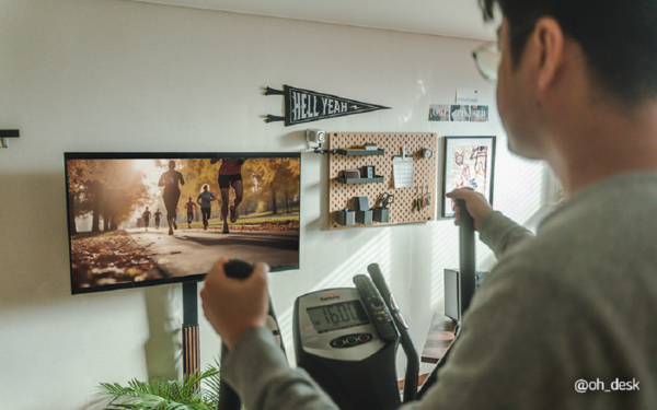 A picture of a person exercising while watching something from the LG OLED TV