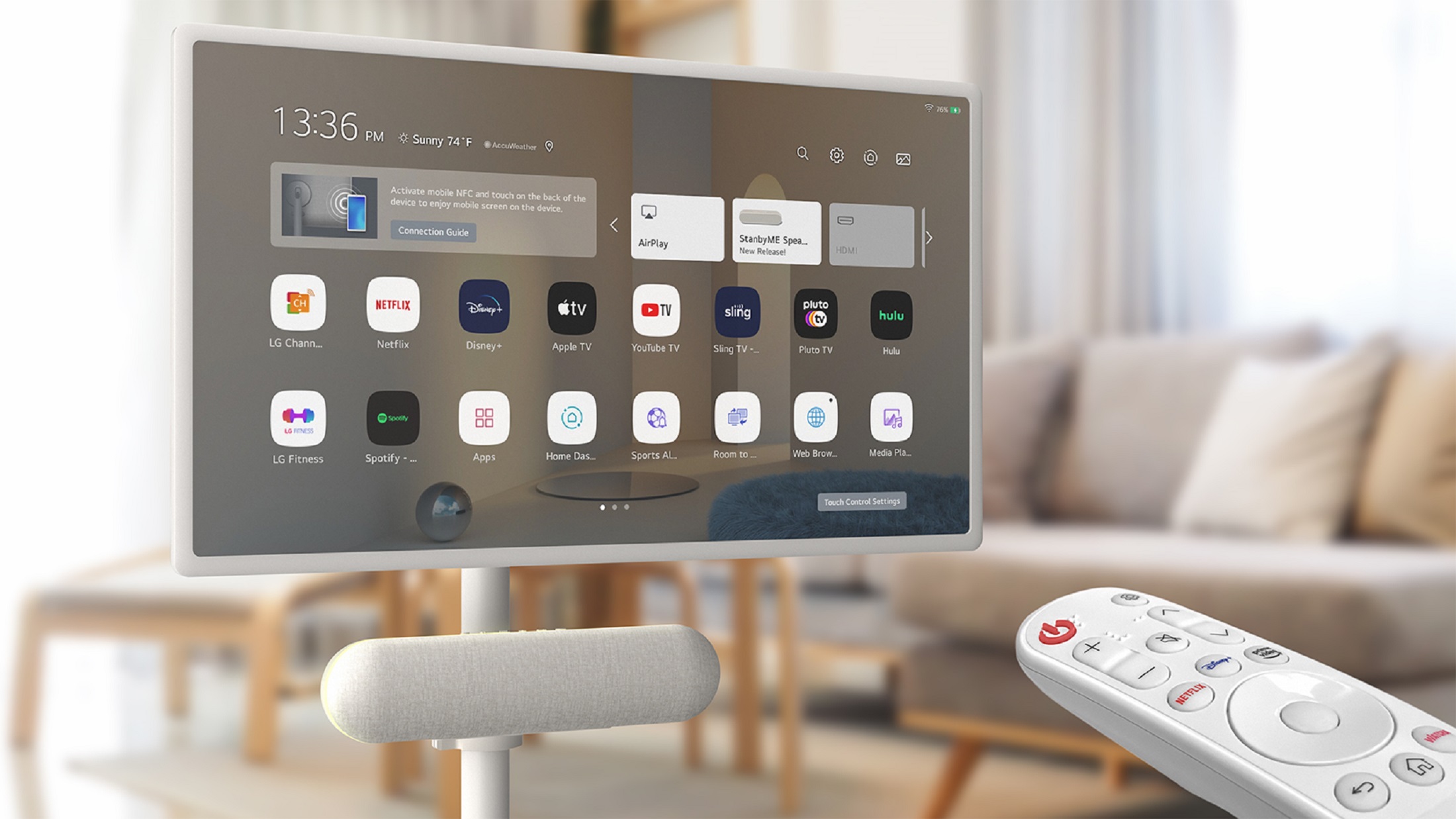 A remote controls an LG StanbyMe and StanbyME Speaker mounted directly under the screen