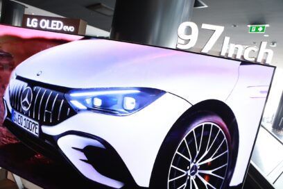 A picture of the LG OLED evo screen with a Mercedes Benz vehicle on it