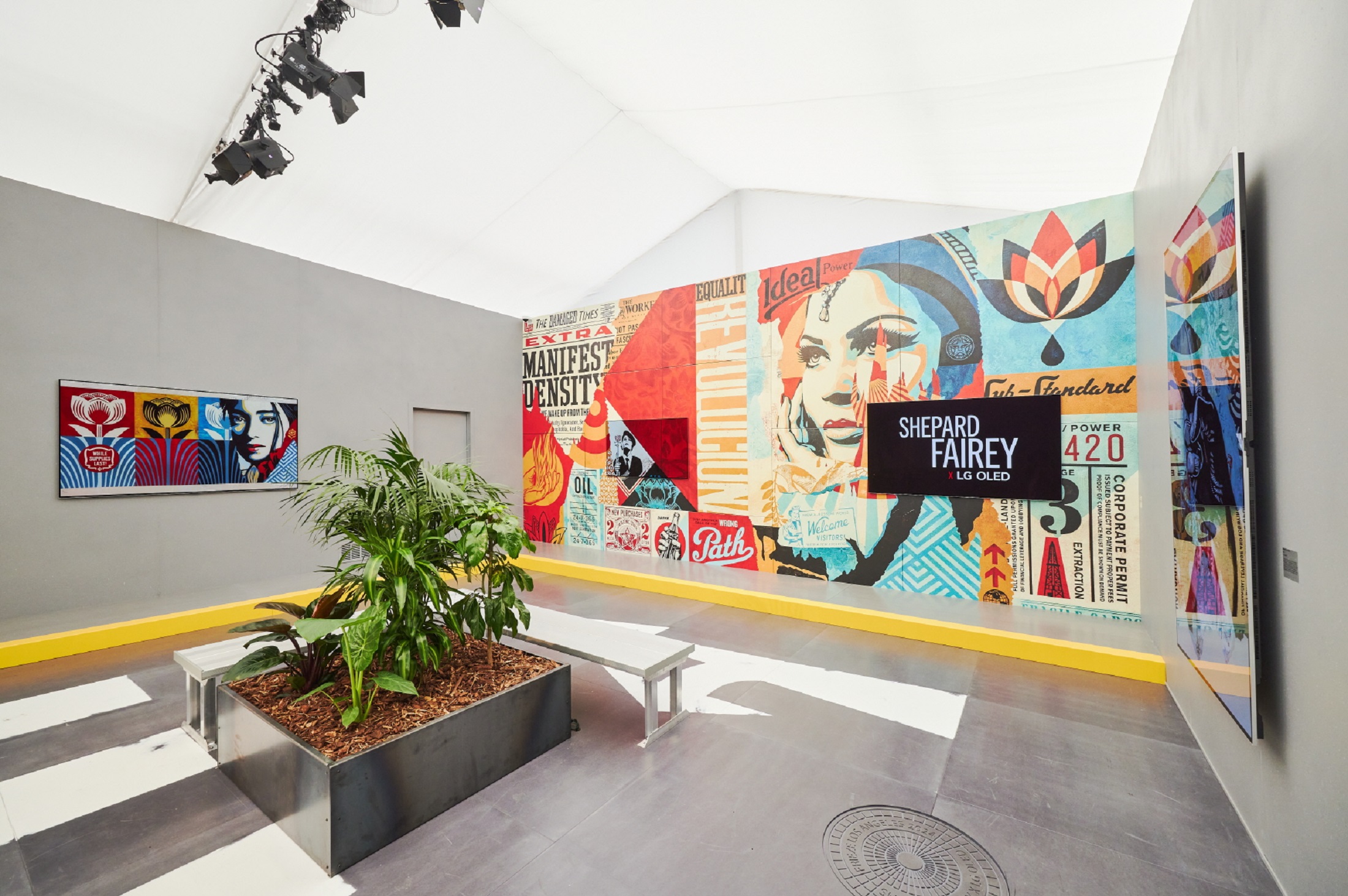 Two LG OLED TVs are positioned above a mural, with the right displaying Shephard Fairey X LG OLED and the left displaying part of the mural