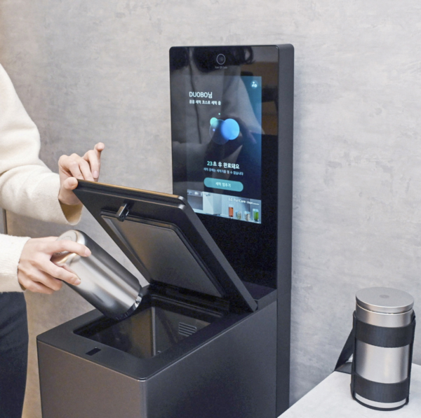 A picture of a person using the mycup tumbler washer