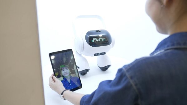 A picture of a person holding a tablet next to the LG AI Agent