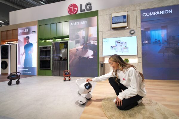 A picture of a woman touching the LG AI Agent in a set up area with LG products