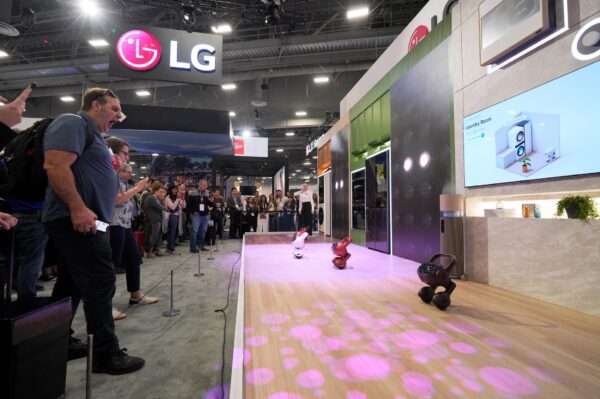 A picture of people looking at the LG AI Agents on display