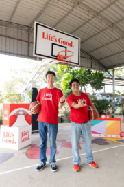 A picture of two men posing for the picture at the basketball court