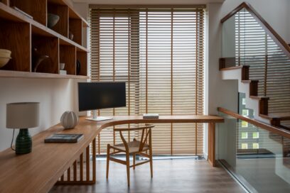 A picture of an area with a desk and chair in the house