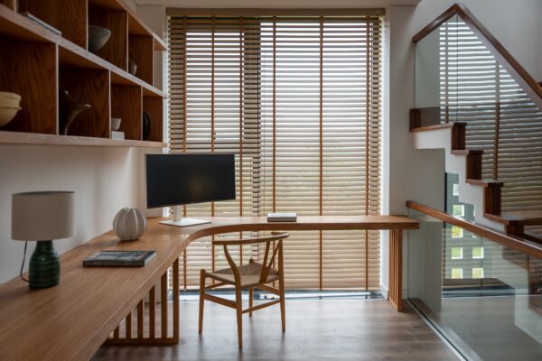 A picture of an area with a desk and chair in the house