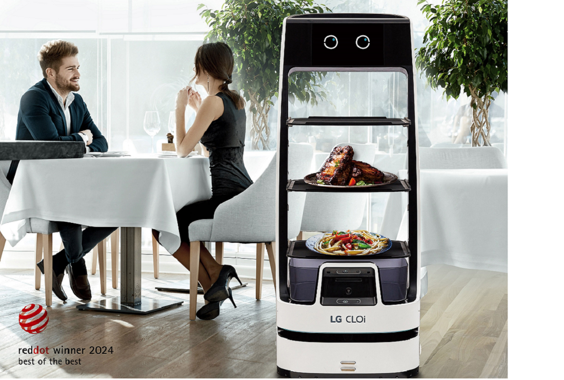 An image of a woman and a man at a restaurant with the LG CLOi ServeBot next to them
