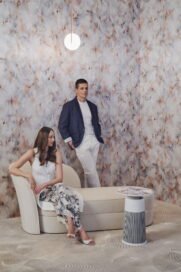 A photo of a woman sitting and a man standing next to the PuriCare AeroFurniture in the LG x Moooi Showroom