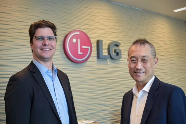 A picture of Darren Sabo and Sokwoo Rhee infront of the LG logo