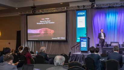 A photo of LG's representative on the stage delivering a speech at AutoTech: Detroit