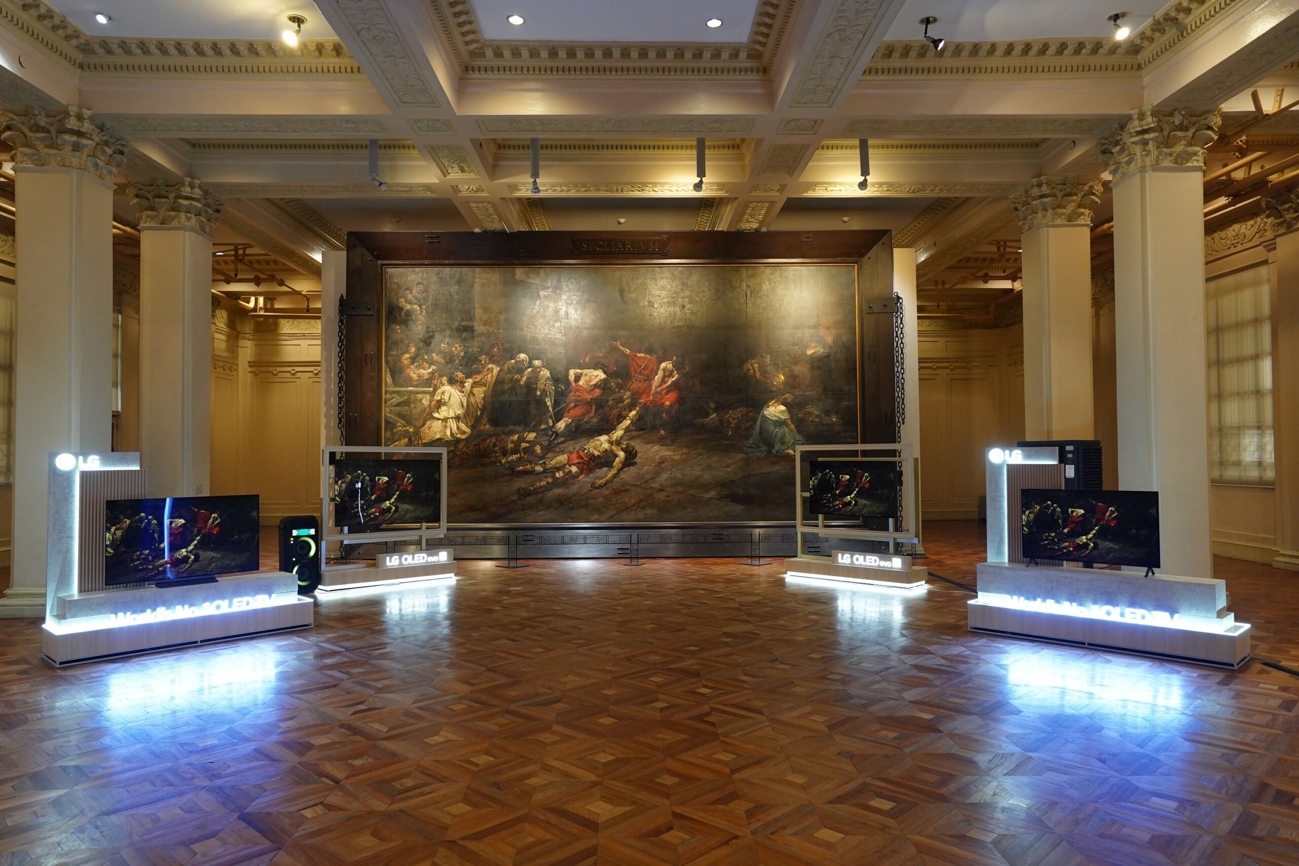 A photo of crowded visitors checking out the LG OLED TVs on display at the gallery