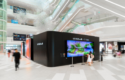 A photo of the exhibition in the mall with people walking by.