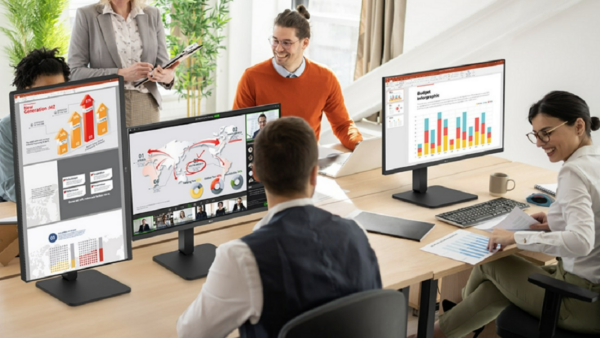 A picture of a group of people working together with different ergonomic monitors