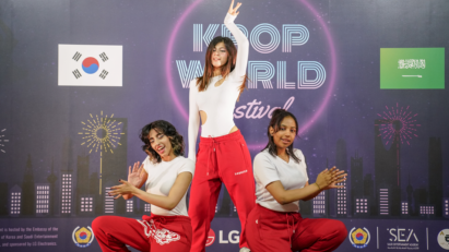 A picture of three girls performing on stage
