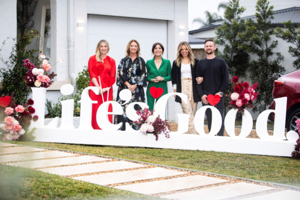A picture of five people standing behind a Life's Good logo