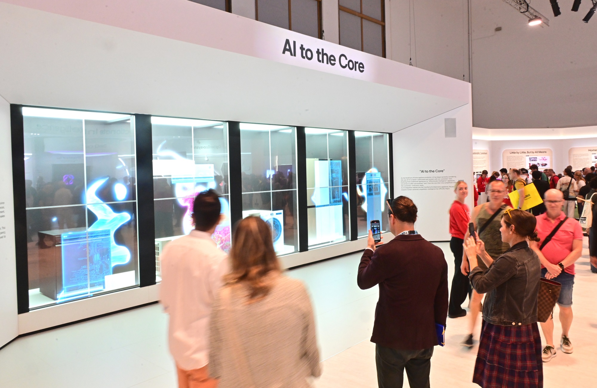 A picture of people gathered around the "AI to the Core" display