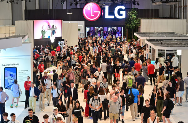 A picture of alot of people walking around LG's booth