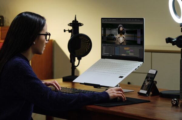 A woman is watching content displayed on the screen from the new LG gram 16 Pro