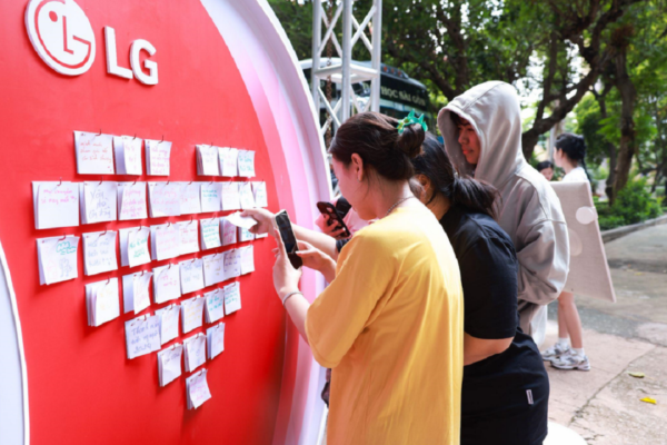 A picture of three students participating in an event with sticky notes