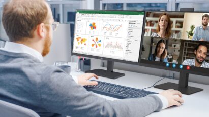 A man is using two LG Business Monitors: one for checking spreadsheet data and the other for attending a meeting