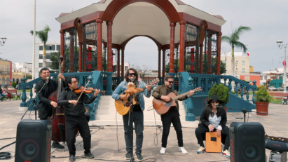 Persian artists with string instruments present a captivating street performance boosted by LG XBOOM speakers in front of a gazebo in a city square