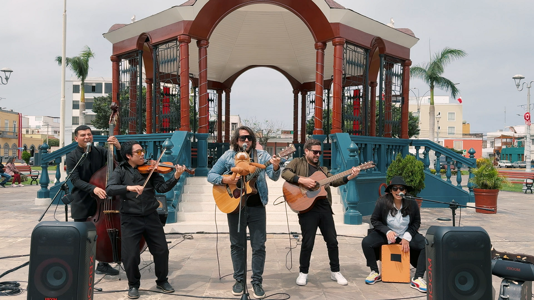 Persian artists with string instruments present a captivating street performance boosted by LG XBOOM speakers in front of a gazebo in a city square