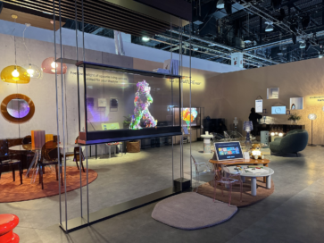 A picture of the showroom with Kartell products and two LG Signature OLED T's