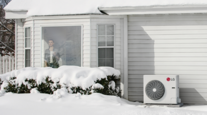 A view of the snow outside the home with LG HVAC products in front of the home