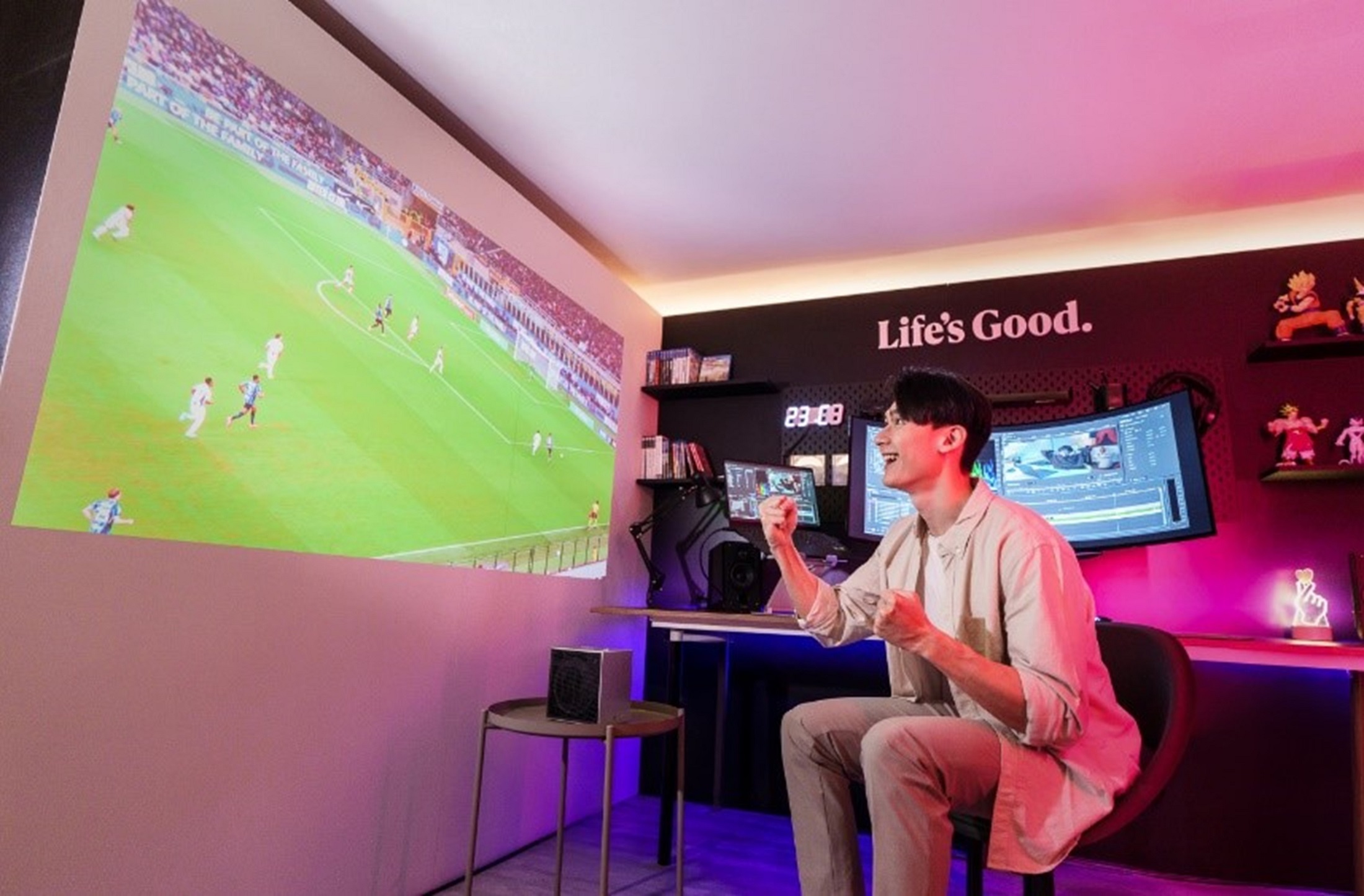 A photo of a man watching a football match via projector