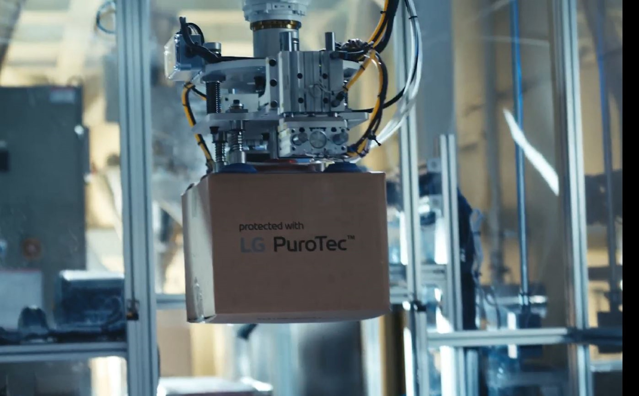 A photo of a machine carrying a box written 'LG PuroTec'