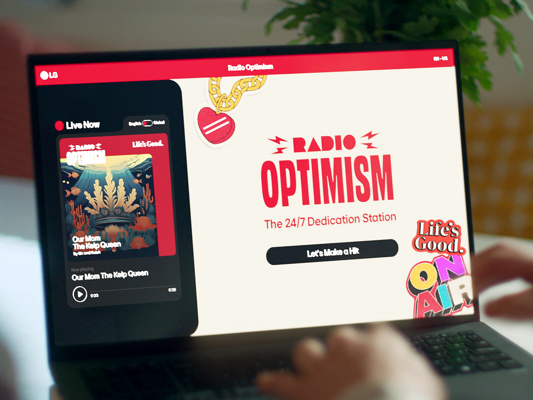 A photo of a laptop displaying the slogan 'Radio Optimism'